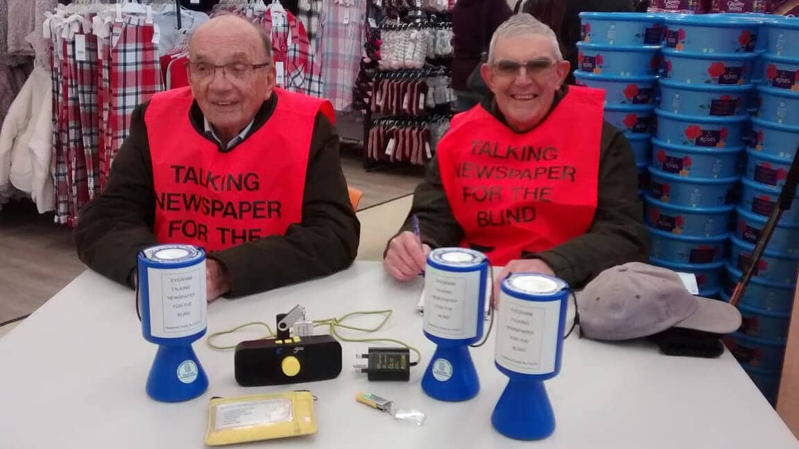 Two volunteers sat down at a table to raise aware and funds at a Tescos store in Evesham