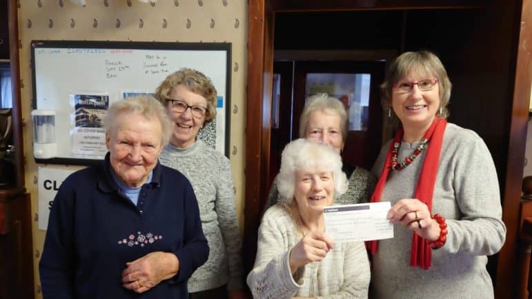 Photo of Evesham volunteer with others at meeting with Offenham Senior Citizens coffee morning